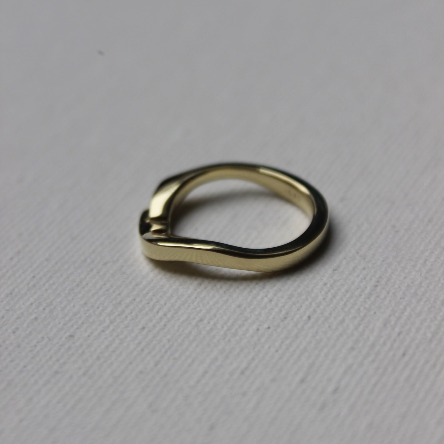 Gold ring on a gray textured background
