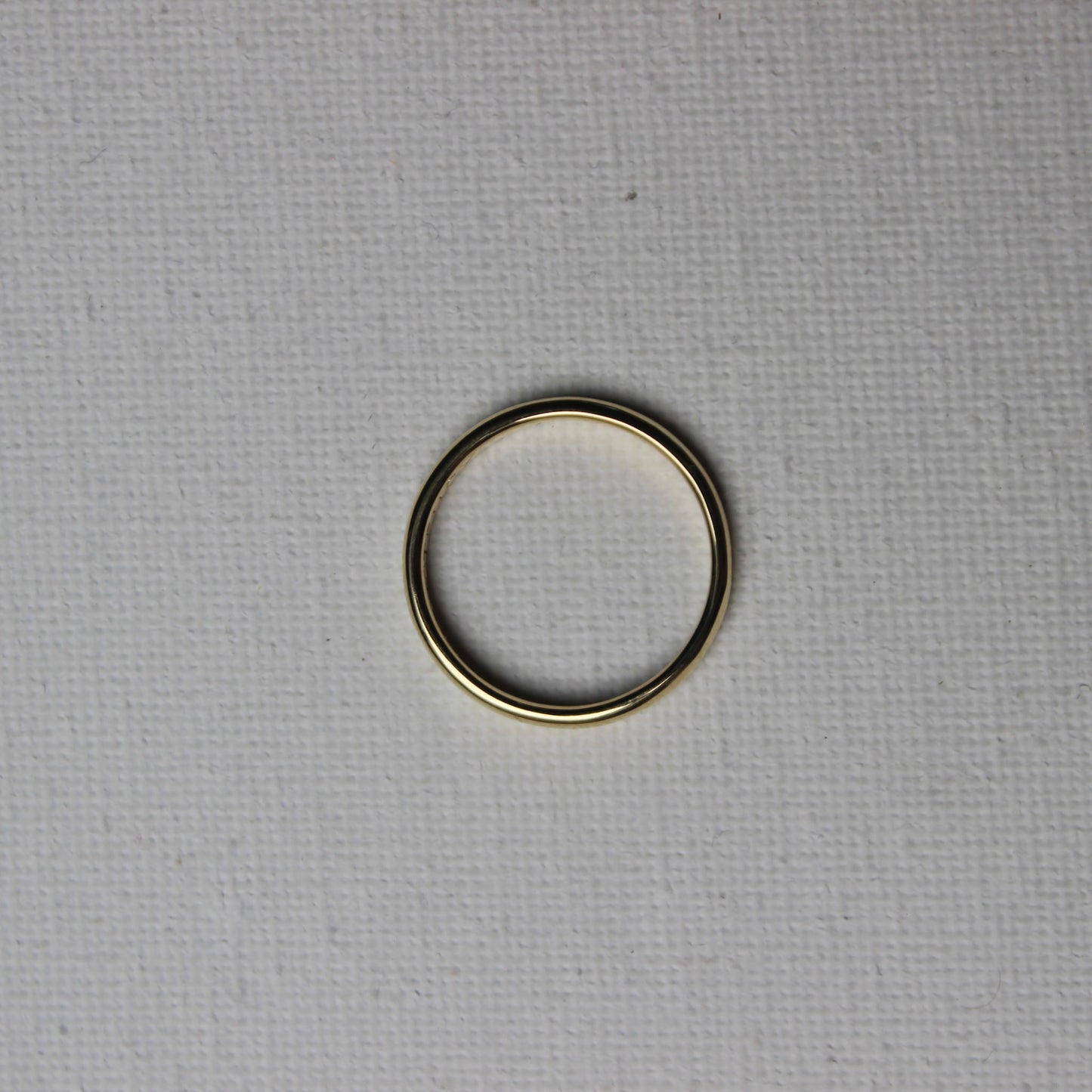 Gold ring on a textured gray background