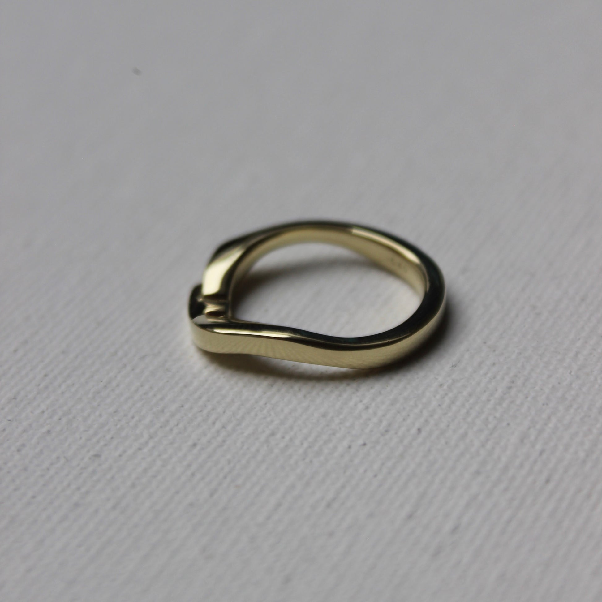 Gold ring on a gray textured background