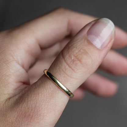 Gold ring on a finger with a blurred background