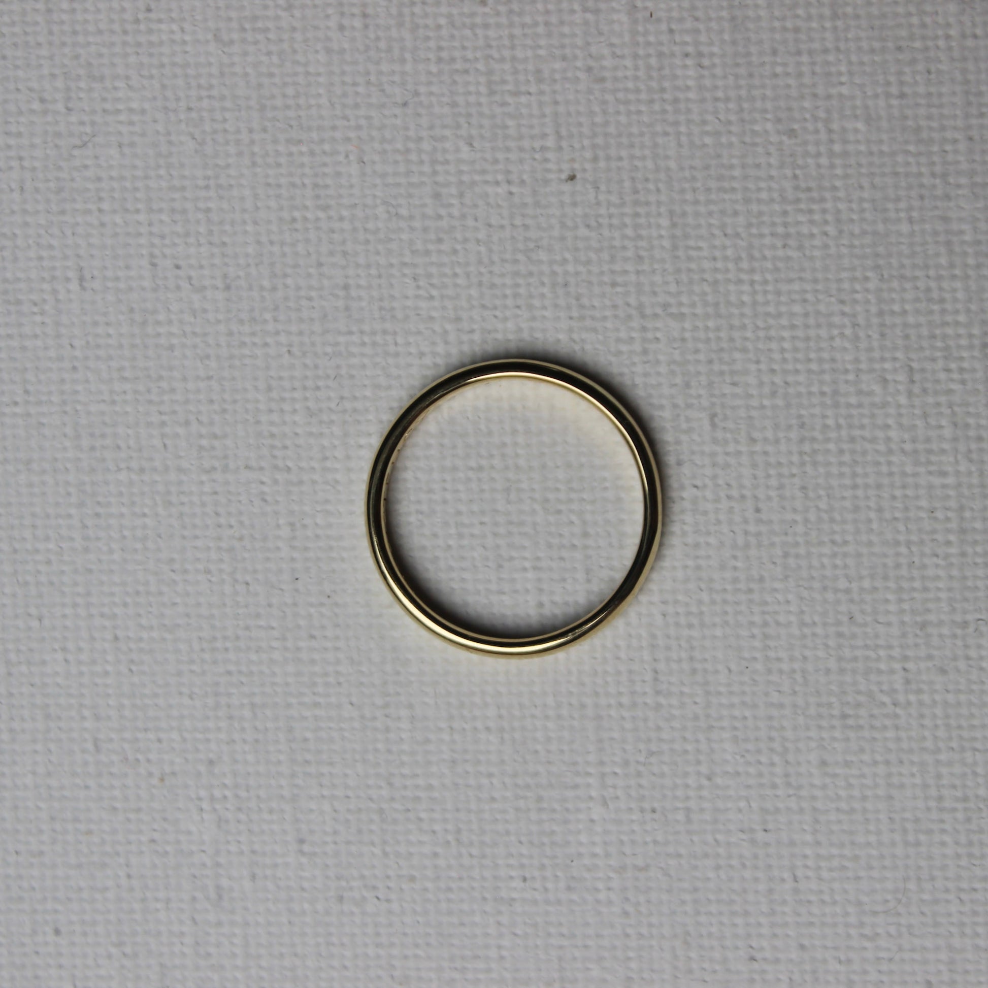 Gold ring on a textured gray background