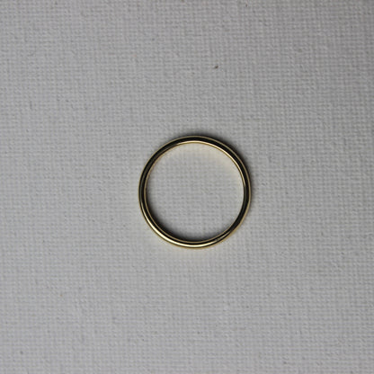 Gold ring on a textured gray background