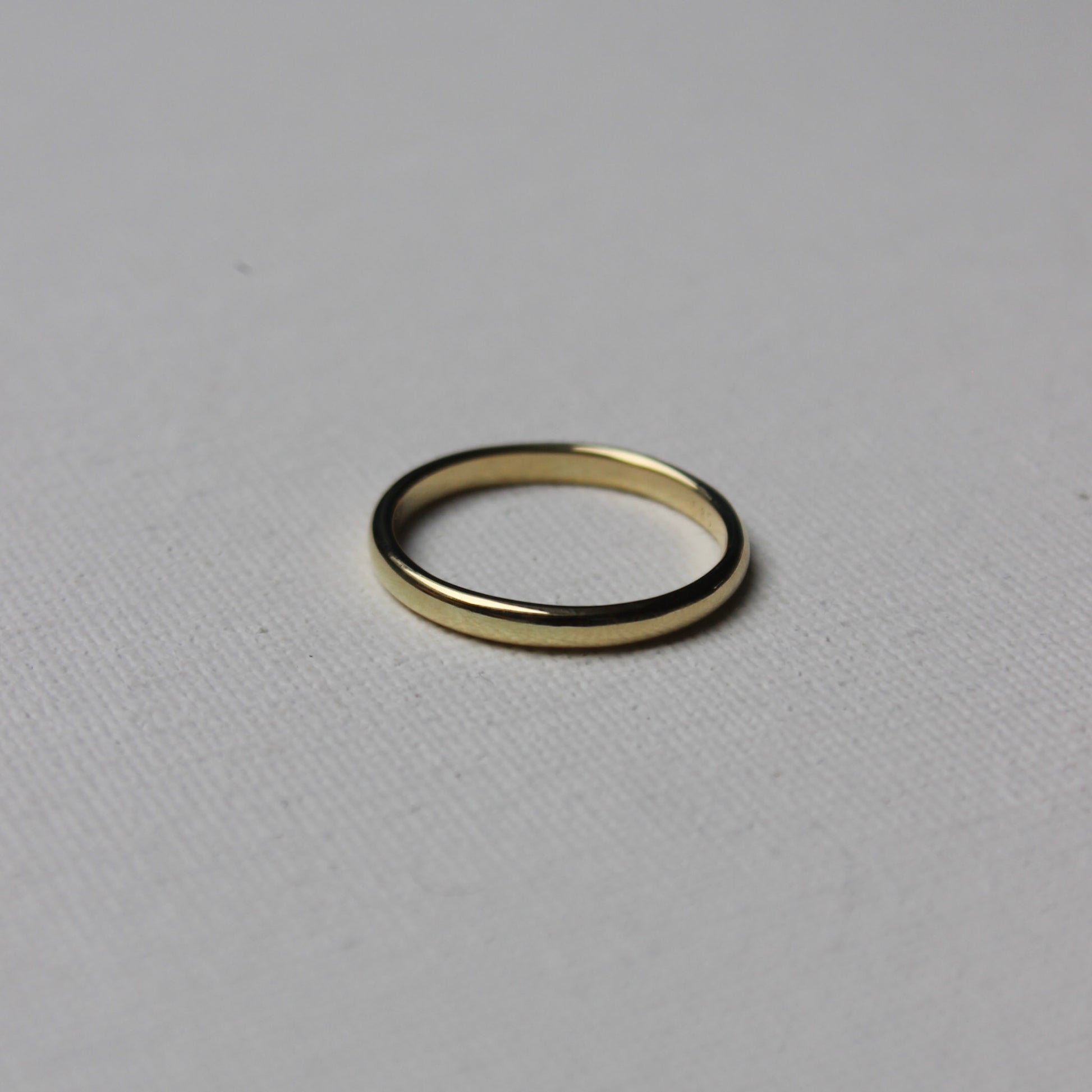 Gold ring on a light gray background