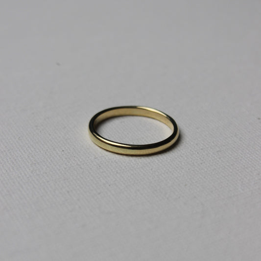Gold ring on a light gray background